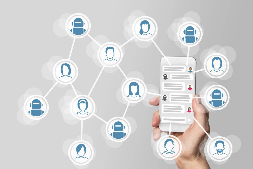 A hand holds a smartphone, its screen alive with messaging app icons linked to various avatars, humans mingled with robots, symbolizing digital communication and AI in the workplace networking.