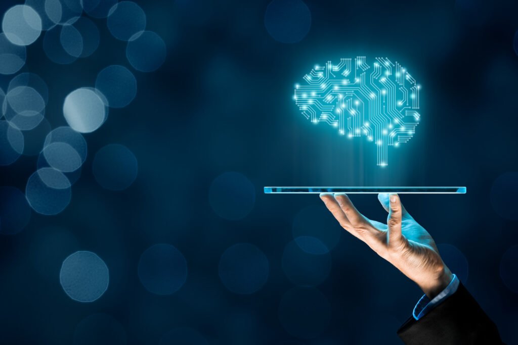 A hand holds a transparent tablet with a digital brain hologram above it, symbolizing the cutting-edge capabilities of penetration and security testing, set against a blue bokeh background.