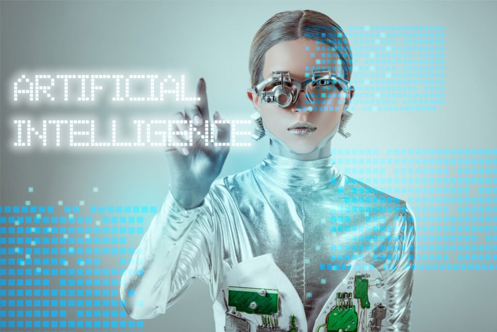 A person in metallic attire and futuristic eyewear engages with digital text displaying AI IN THE WORKPLACE on a virtual interface.