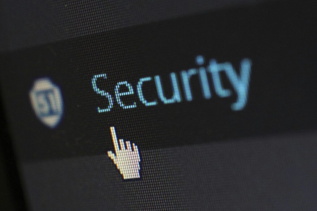 A cursor hovers over the word Security on a digital screen, accompanied by a shield icon, symbolizing the robust protection offered by Microsoft Azure cloud services.