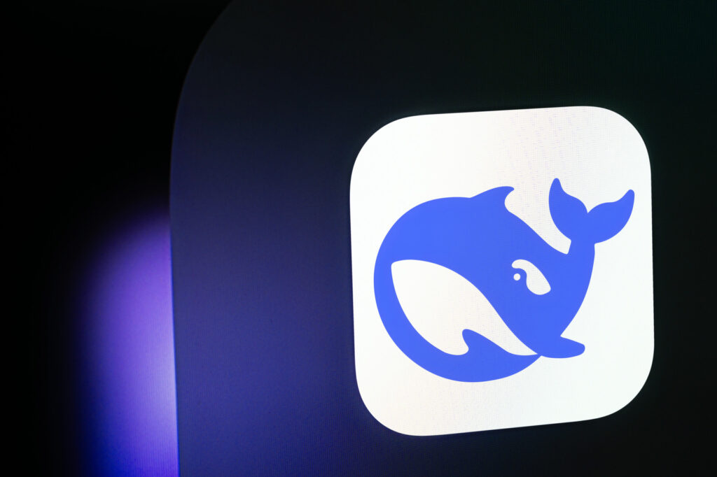 White app icon with a blue whale logo, emanating a deepseek vibe on a dark background with a purple glow.