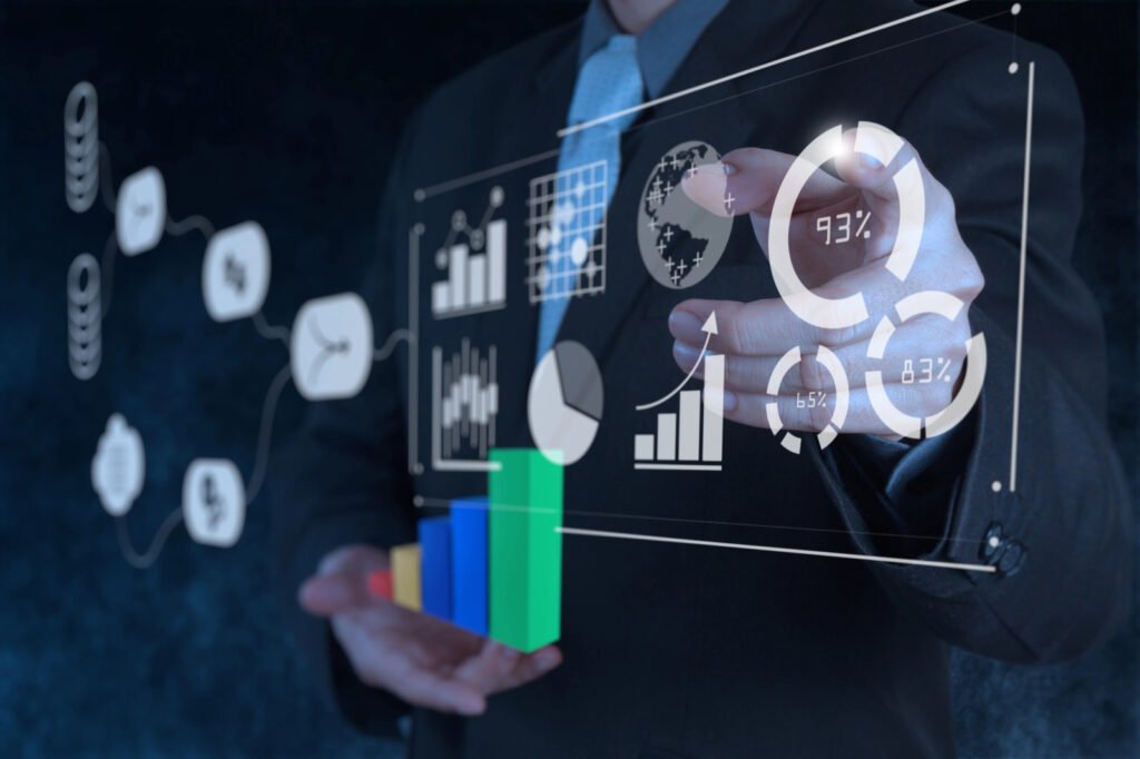 A person in a suit interacts with a virtual display showing various graphs, charts, and statistics, including bar graphs and circular percentage charts, seamlessly integrated with CloudWatch for real-time data insights.